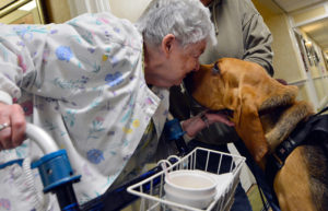 Mary Knitter, 84, shares a kiss with K-9 Bodhi